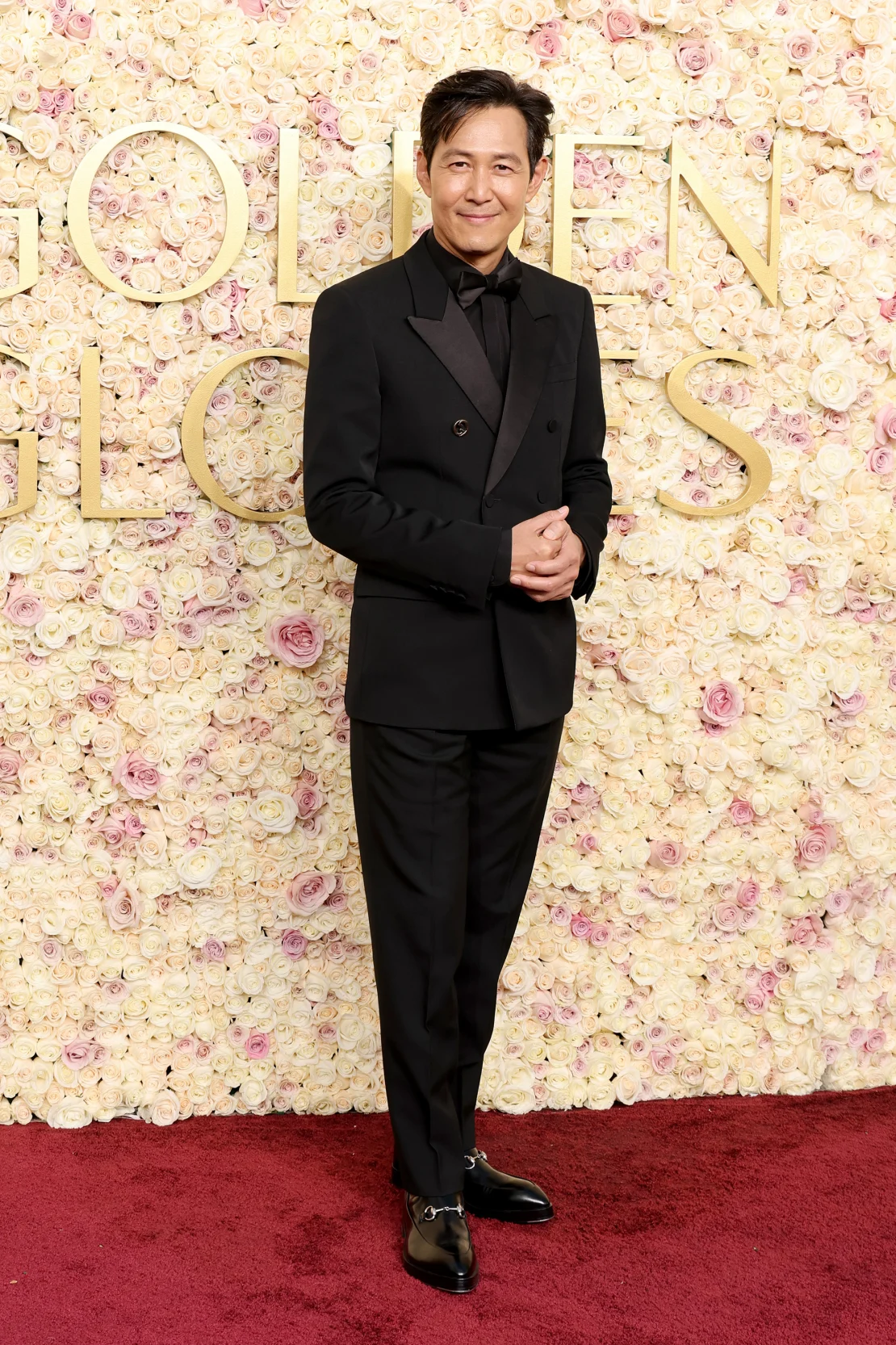 Lee Jung-jae wore a black double-breasted Gucci tuxedo, paired with Horsebit leather boots. Amy Sussman/Getty Images
