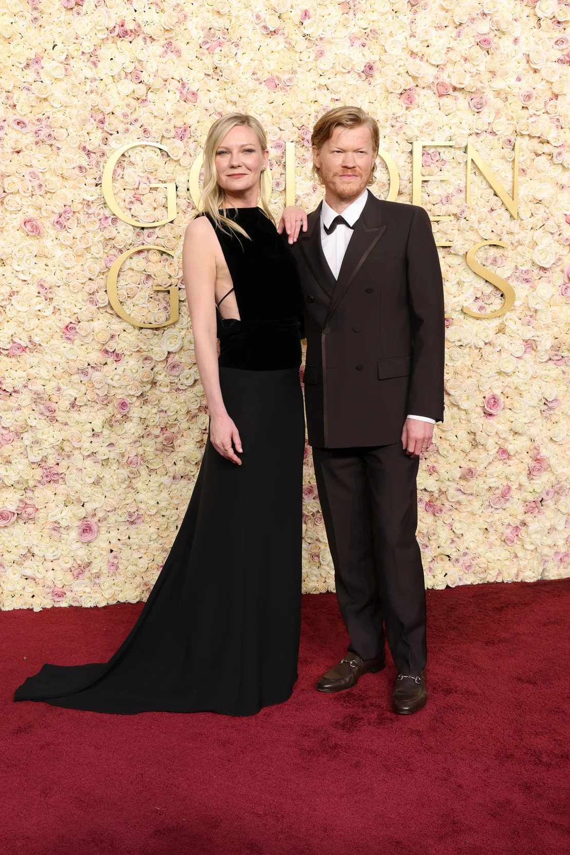 Kirsten Dunst and Jesse Plemons, both in Gucci. Dunst's drop-waist dress was inspired by the 1930s, while Plemon's wore a brown wool double-breasted suit and Horsebit loafers at the 82nd Golden Globes Awards held at the Beverly Hilton, Beverly Hills, California on Sunday, January 5, 2025. | Amy Sussman/Getty Images