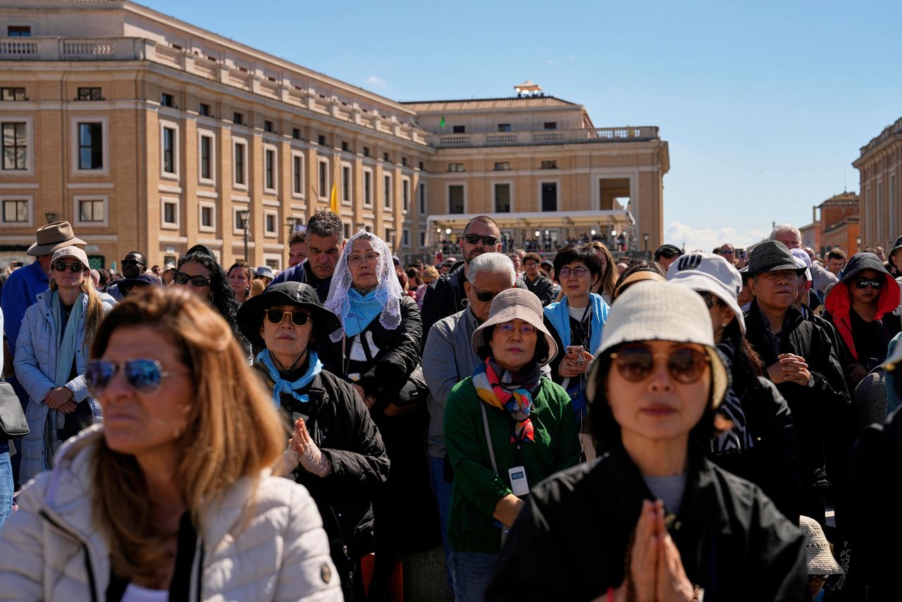 People attend the pope’s funeral in St. Peter's Square. Andreea Alexandru/AP