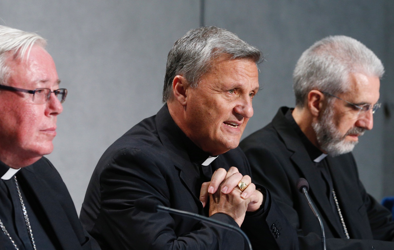 Cardinal Mario Grech, secretary-general of the Synod of Bishops, speaks during a news conference to present an update on the synod process at the Vatican Aug. 26, 2022. Also pictured are Cardinal Jean-Claude Hollerich of Luxembourg, relator general of the synod, left, and Bishop Luis MarÌn de San MartÌn, undersecretary of the synod. | CNS photo/Paul Haring
