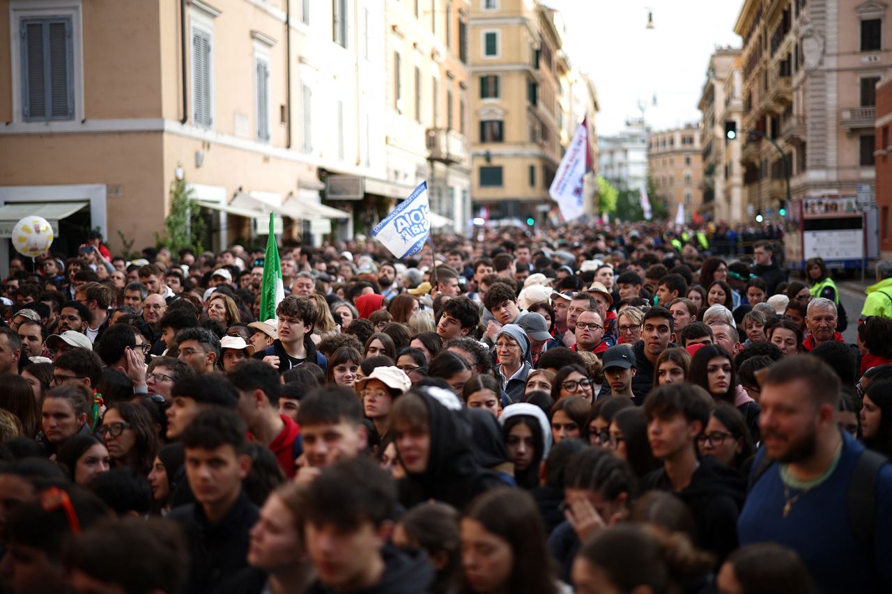People crowd on a street in Rome ahead of late Pope Francis' funeral on Saturday. Henry Nichols/AFP/Getty Images