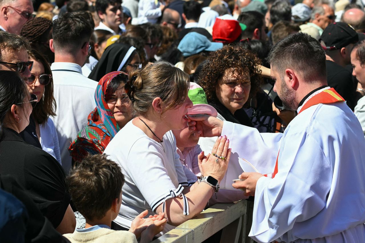 Attendees receive communion wafers during late Pope Francis' funeral at St Peter's Square. Andreas Solaro/AFP/Getty Images