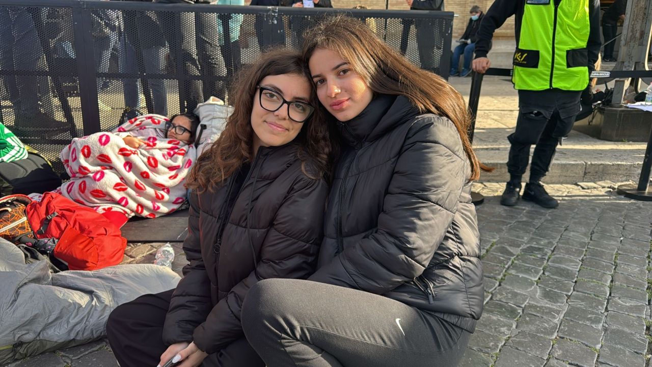 Young devotees Sophia Amato, right, pictured with her friend Irene Amartimo camp overnight at the St. Peter Basilica for the funeral of the pontiff on April 26, 2025. | Brent Swails/CNN