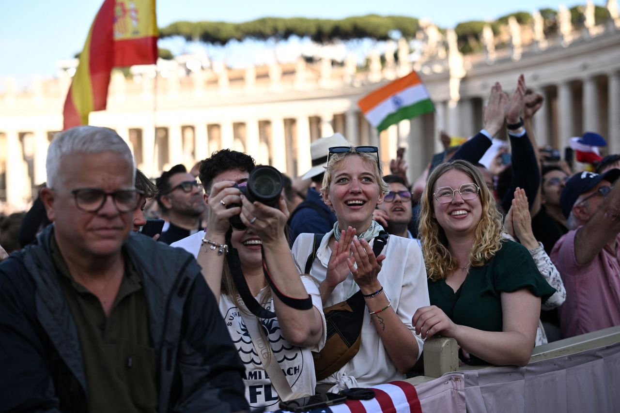 People react as white smoke rises from the chimney on the Sistine Chapel on Thursday, May 8, 2025. | Dylan Martinez/Reuters