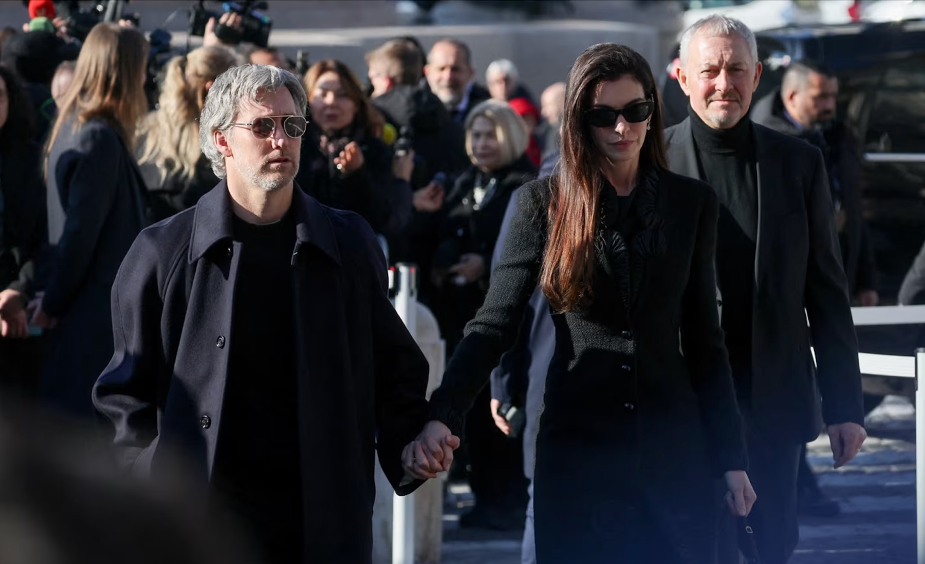 Actor Anne Hathaway and her husband, Adam Shulman, attend the funeral ceremony for Italian fashion designer Valentino Garavani at the Basilica of Santa Maria degli Angeli e dei Martiri in Rome on Friday, January 23, 2026. | Yara Nardi/Reuters