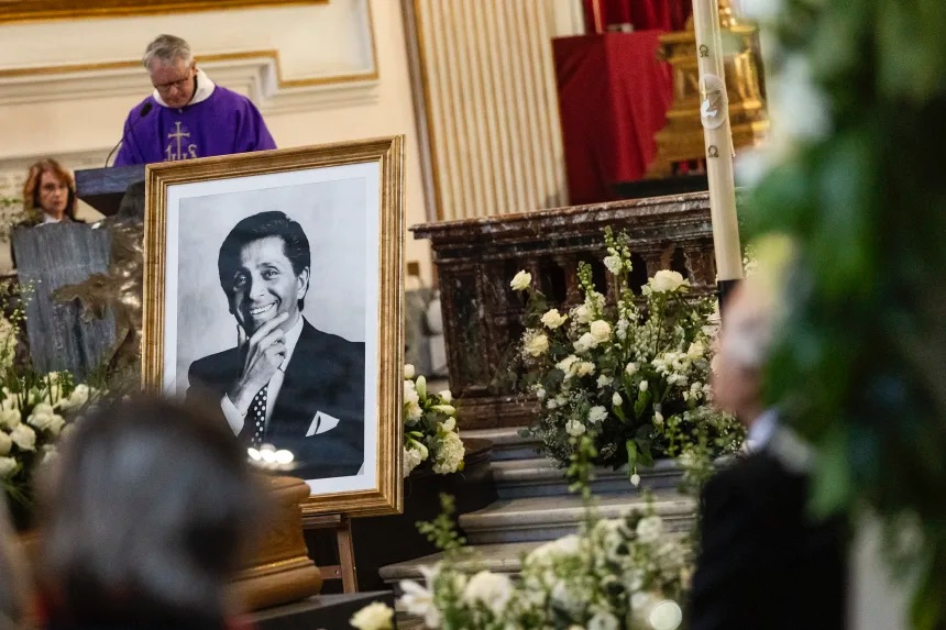 A portrait of the late designer is displayed inside the Basilica of Santa Maria degli Angeli e dei Martiri during Valentino Garavani’s funeral ceremony in Rome on Friday, January 23, 2026.