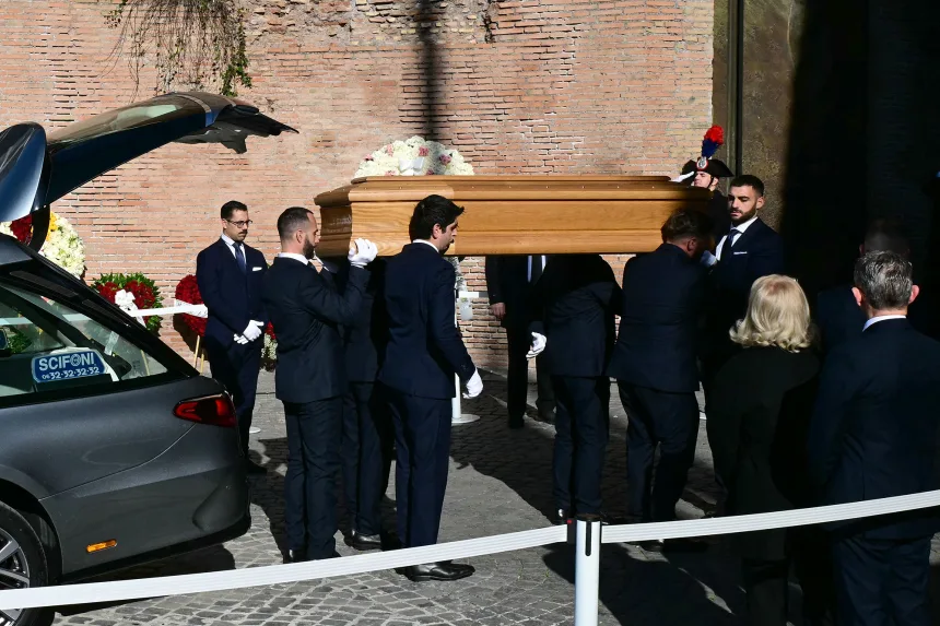Pallbearers carry the coffin of Valentino Garavani into the Basilica of Santa Maria degli Angeli e dei Martiri for his funeral ceremony in Rome on Friday, January 23, 2026. | Stefano Rellandini/AFP/Getty Images