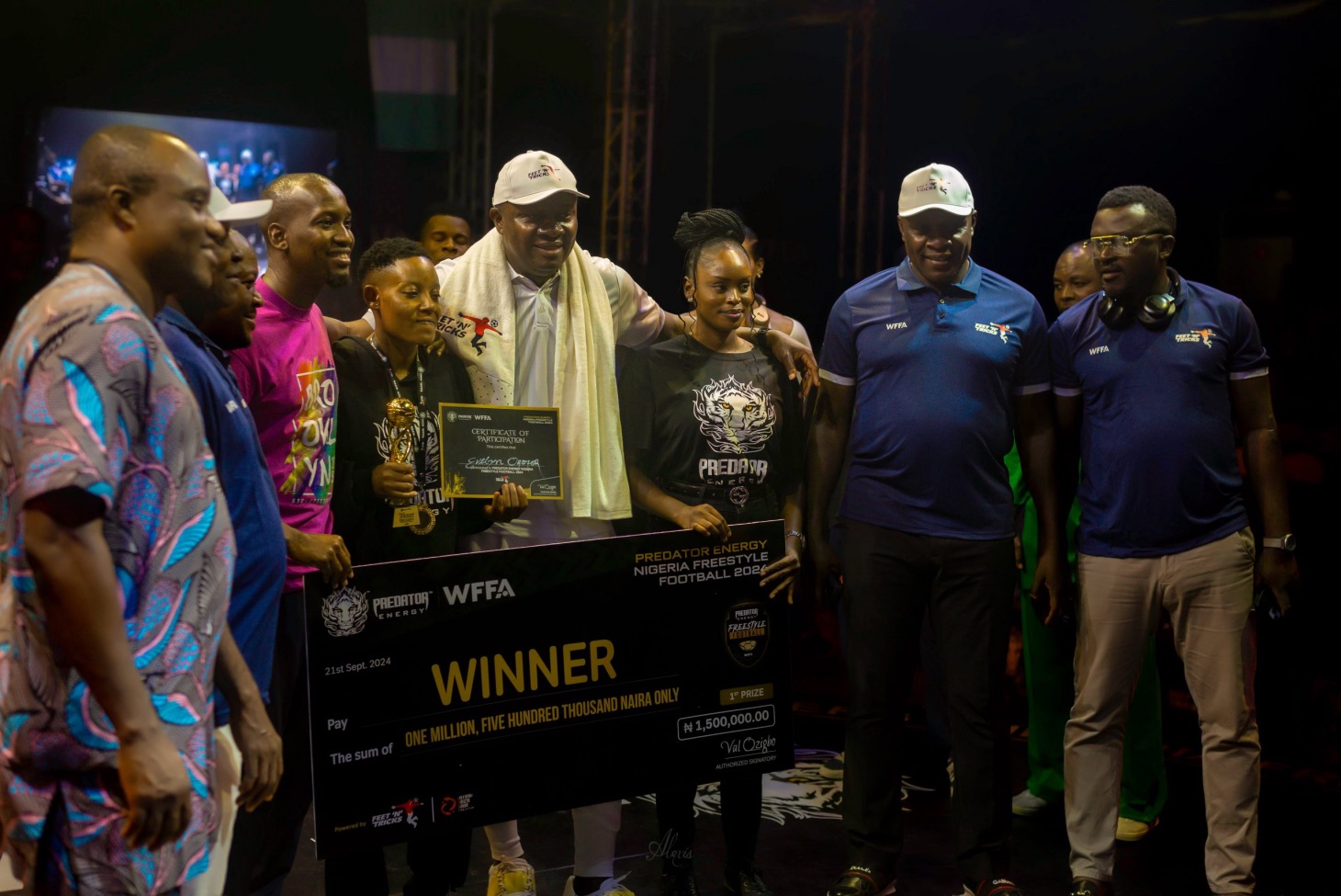 Evelyn Okafor, winner of the women’s category, receives her trophy and ₦1.5 million prize at the Predator Energy Nigerian Freestyle Football Championship 2024, held in Lagos on Saturday, September 21, 2024. She is joined by Valentine Ozigbo, Chairman of Feet ’ N’ Tricks International, and Oraka Nvy (in pink), Managing Director of Feet ’ N’ Tricks International, alongside representatives of the World Freestyle Football Association. | Alexis Photos/FNT