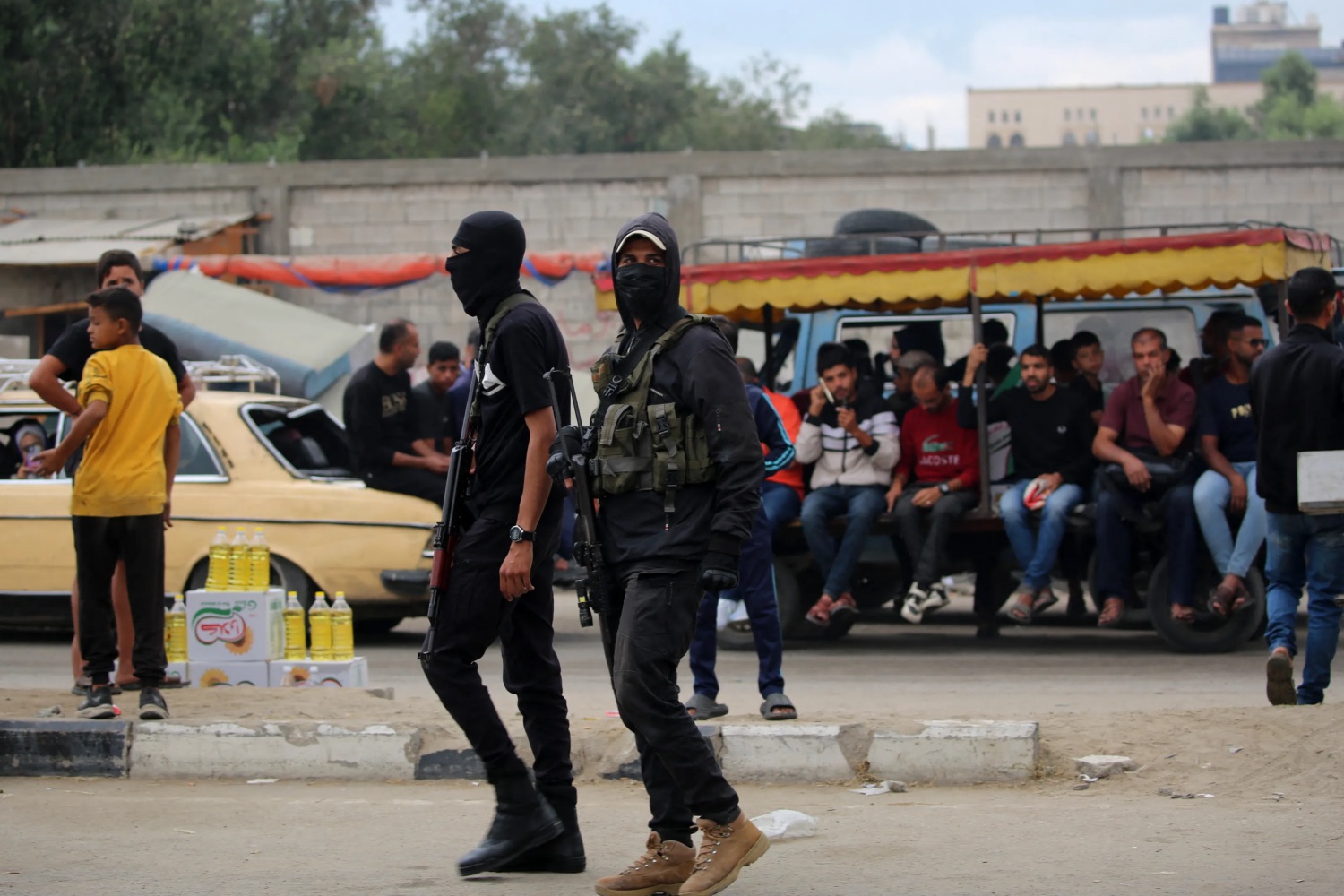 Members of the internal security forces loyal to the Palestinian group Hamas are deployed in the Nuseirat refugee camp in the central Gaza Strip, as displaced people return to Gaza City, on October 12, 2025. Israel declared a ceasefire in Gaza and began to pull back its forces on October 10, as tens of thousands of exhausted Palestinians made their way back to their devastated homes. | Eyad Baba/AFP 
