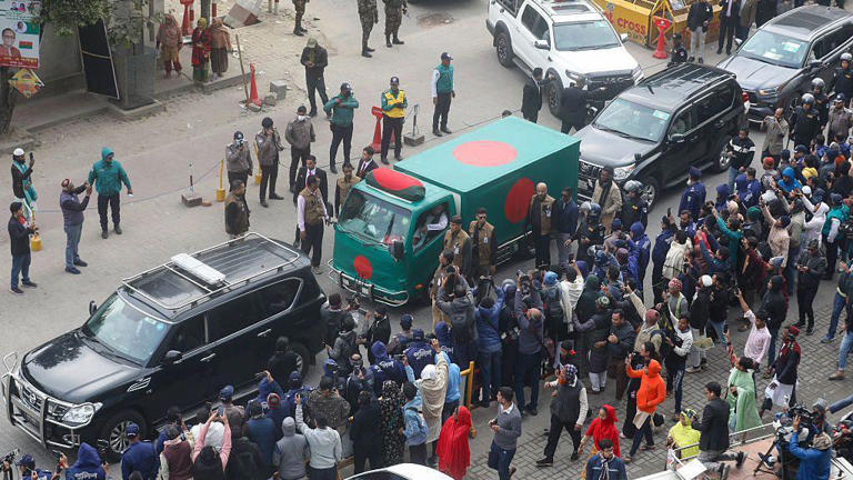A hearse covered in Bangladesh's flag carried Zia's body through the streets of Dhaka on Wednesday, December 31, 2025. | AFP via Getty Images
