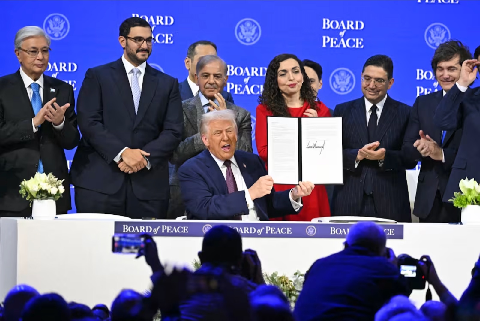 President Donald Trump holds a signing founding charter at the "Board of Peace" meeting Thursday, January 22, 2026 in Davos,