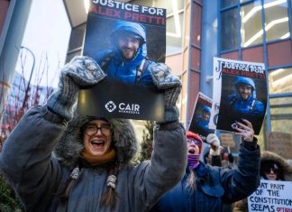 ICE Agents Placed on Leave After Fatal Shooting of Alex Pretti in Minneapolis Protesters gathered outside the office of Minnesota senator Amy Klobuchar on Monday, Jan. 26, 2026, following the shooting. | AFP viaGetty Images