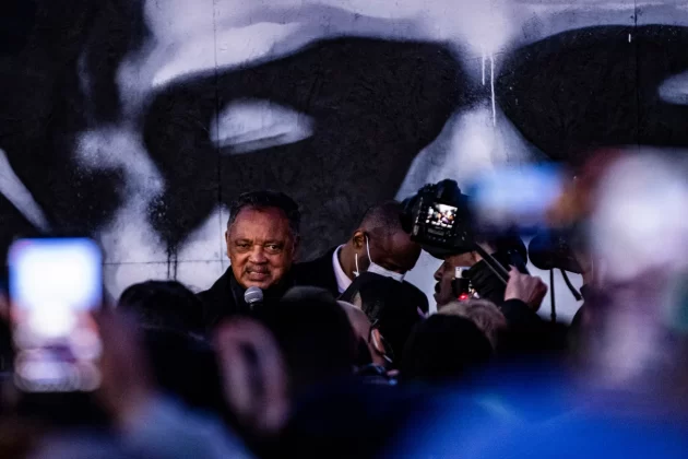 Jackson speaks in front of a Minneapolis mural of George Floyd in April 2021 after a jury found former police