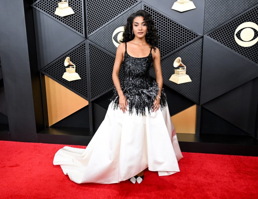 Olivia Dean LOS ANGELES, CA – FEBRUARY 2026: Olivia Dean arrives on the red carpet at the 68th Grammy Awards wearing Chanel and Cartier. | Amy Sussman/Getty Images