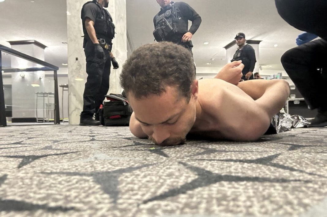  Law enforcement personnel detain Cole Tomas Allen, a suspect in the shooting incident at the White House Correspondents' Association dinner, in Washington, D.C., U.S. April 25, 2026. | DONALD J TRUMP via Truth Social/Handout