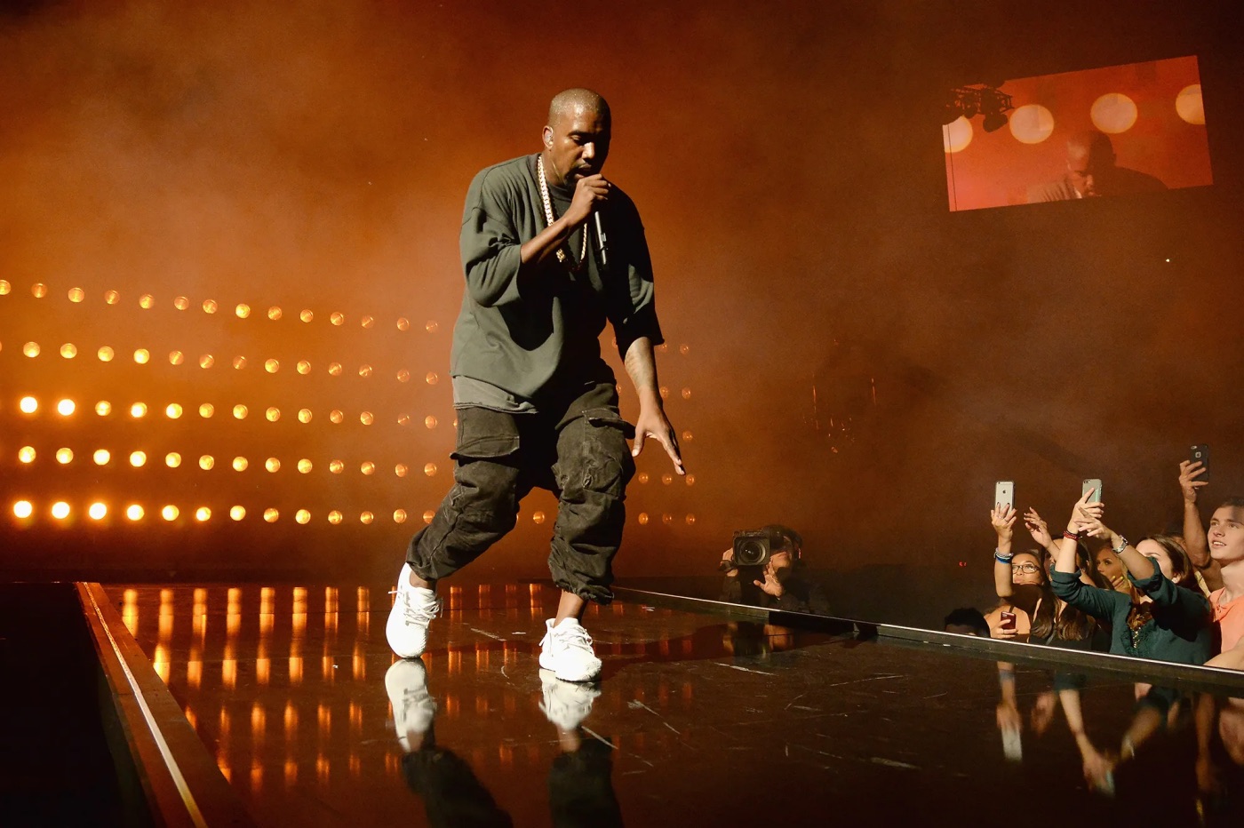 Kanye West performs on stage.