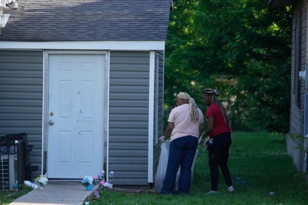 People clean up outside the scene on Sunday. Gerald Herbert/A