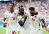 Saka Hat-Trick Powers England to 6-4 Win Over France in World Cup Bronze Final England's Bukayo Saka celebrates scoring their fifth goal to complete a hat-trick with Jude Bellingham and Reece James during Saturday's World Cup third place match.