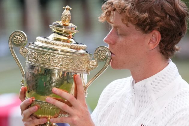 Jannik Sinner of Italy kisses his trophy after winning against Alexander Zverev of Germany in the men&rsquo;s singles final at Wimbledon Tennis Championships in London, Sunday, July 12, 2026. | AP Photo/Kirsty Wigglesworth