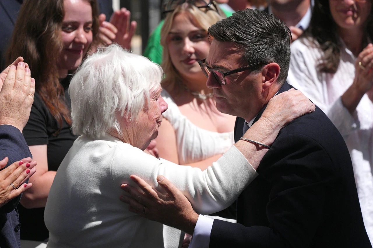 Andy Burnham kisses his mother, Eileen Burnham, as he arrives in Downing Street after becoming Britain’s new prime minister in London on