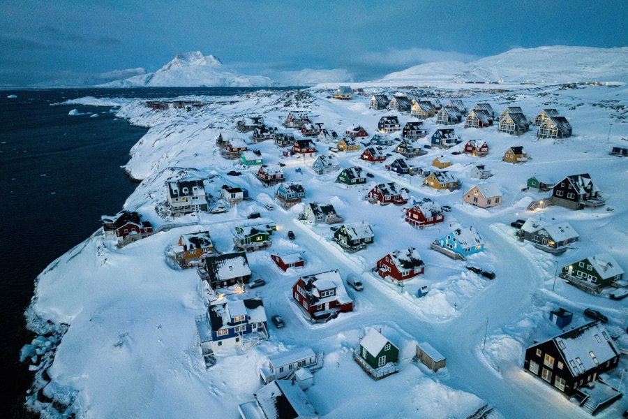 NUUK, GREENLAND – MARCH 7: Snow-covered houses line the coast of a sea inlet in Nuuk, Greenland, on Friday, March 7, 2025. 