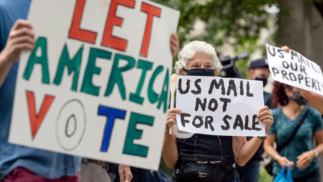 Protesters demonstrate in front of the home of then-Postmaster General Louis DeJoy over mail-in balloting concerns.