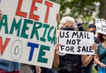 US Supreme Court Blocks Trump’s Mail Ballot Rules Ahead of the Midterm Elections Protesters demonstrate in front of the home of then-Postmaster General Louis DeJoy over mail-in balloting concerns.