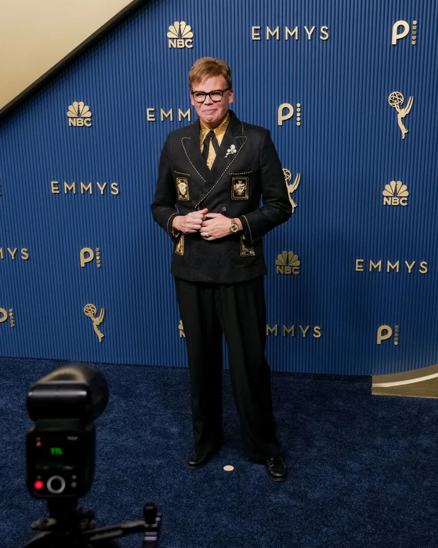 Jeff Hiller attends the 78th Primetime Emmy Awards in Los Angeles wearing an embroidered Bode suit over a gold shirt, September 14, 2026. | 