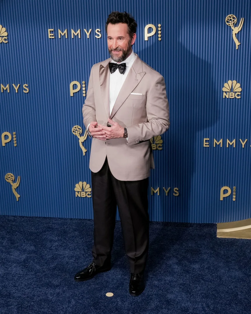 Noah Wyle attends the 78th Primetime Emmy Awards at the Peacock Theater in Los Angeles on September 14, 2026, wearing a custom Brunello Cucinelli tuxedo with a taupe jacket and black trousers. 