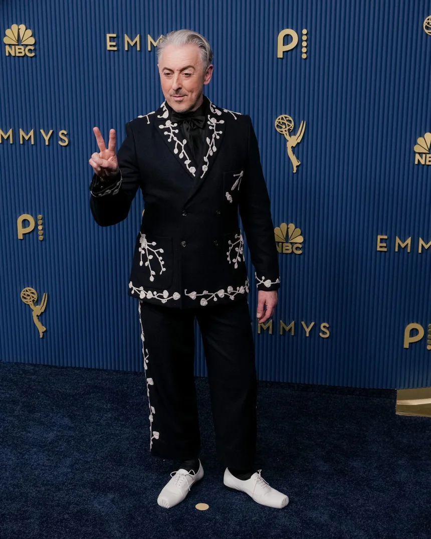 Alan Cumming attends the 78th Primetime Emmy Awards at the Peacock Theater in Los Angeles on September 14, 2026, wearing an embroidered black Bode suit.
