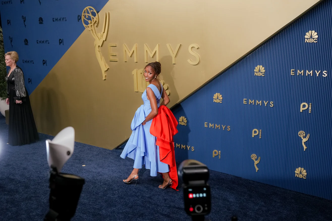 Ayo Edebiri attends the 78th Primetime Emmy Awards at the Peacock Theater in Los Angeles on September 14, 2026, wearing a custom blue Chanel dress finished with an oversized vermilion-red bow at the back.