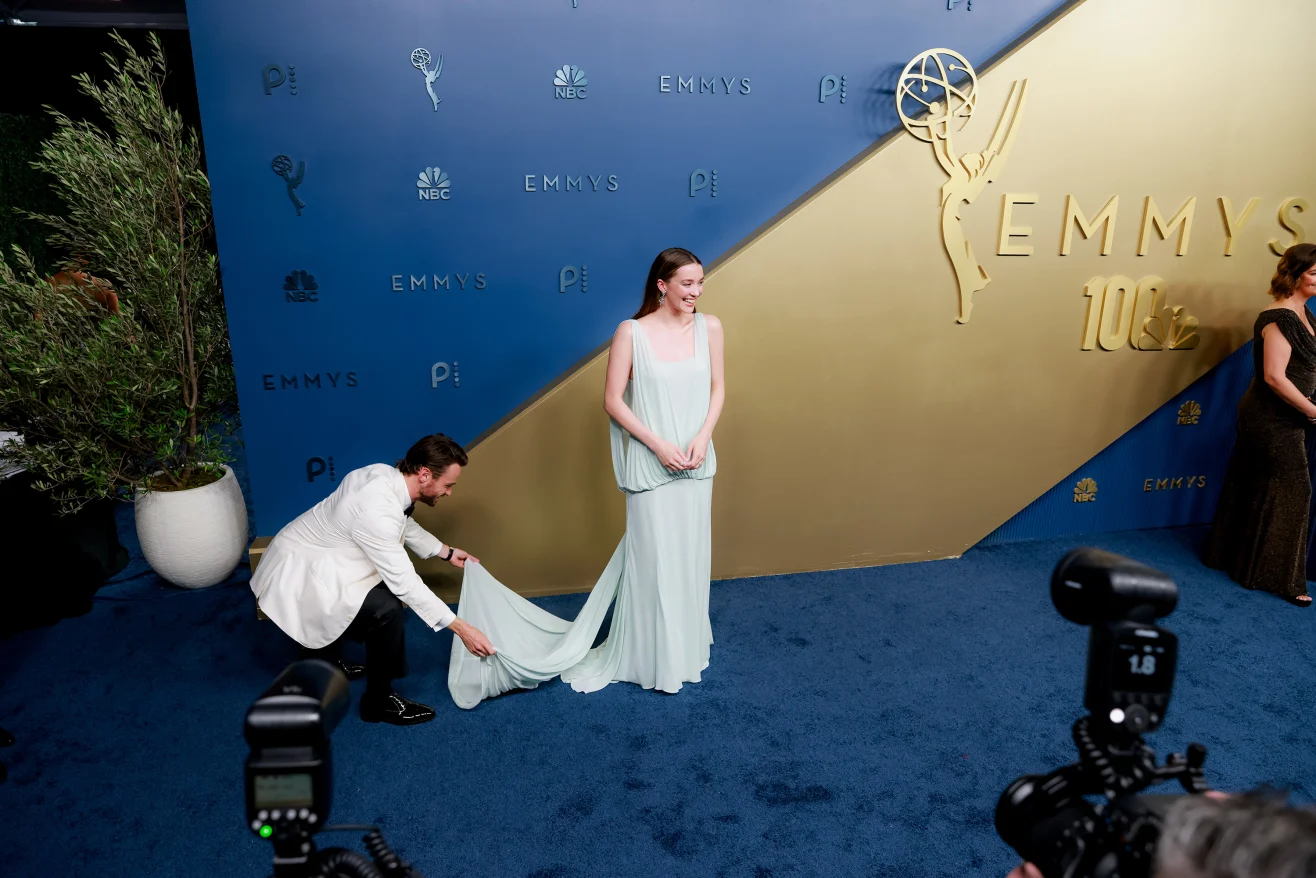 LOS ANGELES, CALIFORNIA – SEPTEMBER 14: “Paradise” actor Thomas Doherty adjusts the train of co-star Nicole Brydon Bloom’s pale blue Lein Studio gown as they attend the 78th Primetime Emmy Awards at the Peacock Theater on Monday, September 14, 2026. | Jennelle Fong for CNN