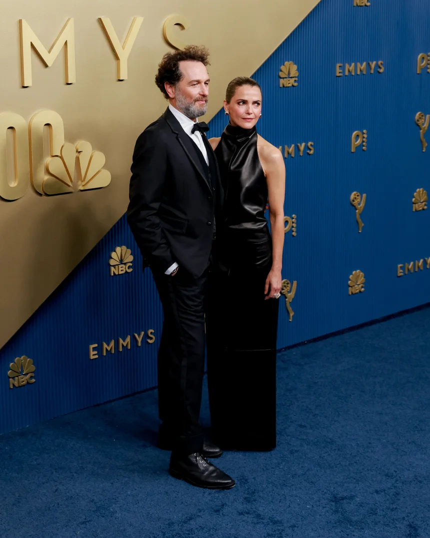 LOS ANGELES, CALIFORNIA – SEPTEMBER 14: Actors Matthew Rhys and Keri Russell attend the 78th Primetime Emmy Awards at the Peacock Theater on Monday, September 14, 2026. Rhys wears a black Thom Browne tuxedo, while Russell wears a floor-length black leather gown by Khaite. | Jennelle Fong for CNN