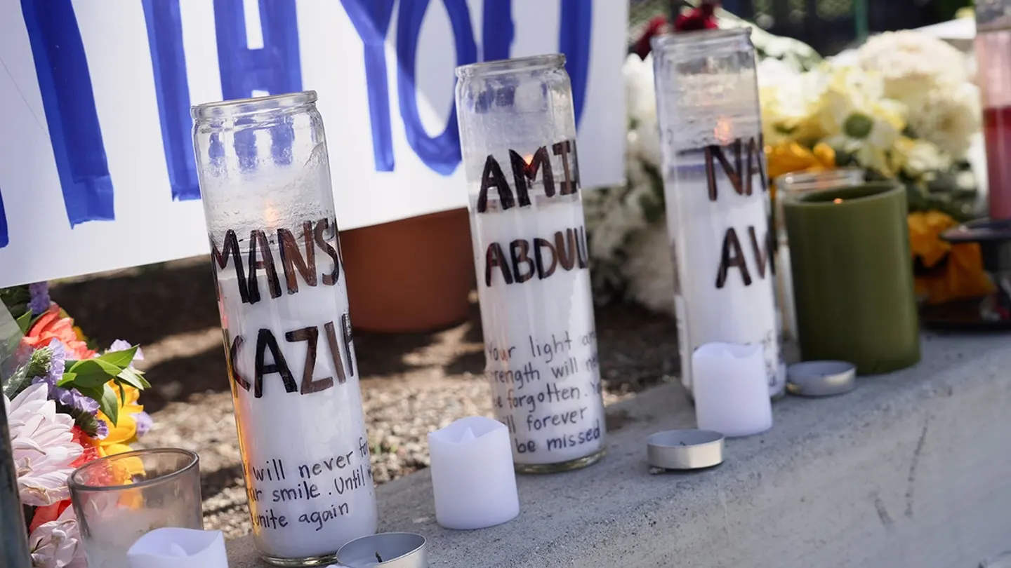 Candles bearing the names of victims are placed outside the Islamic Center of San Diego on May 20, 2026.