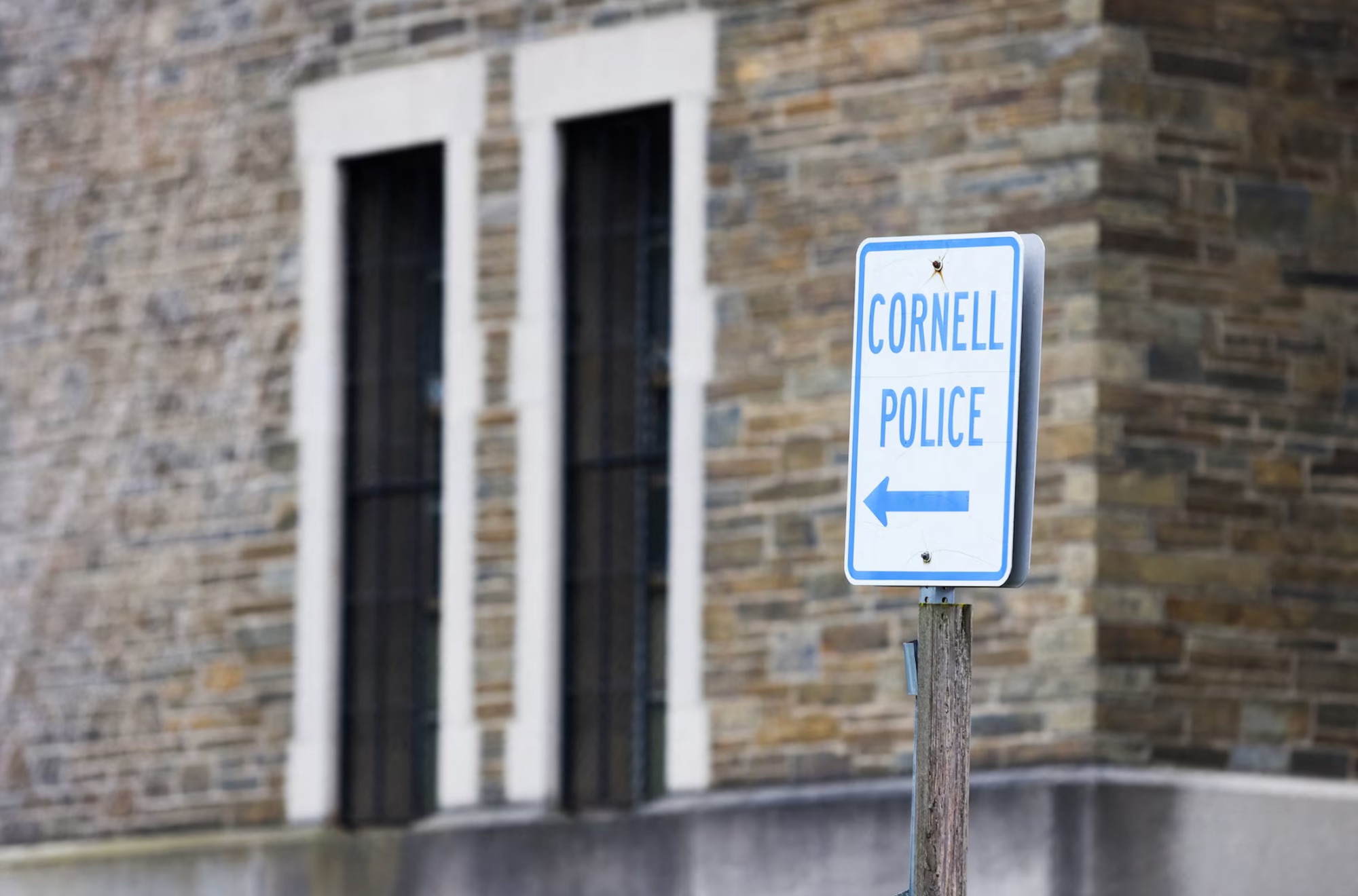 A sign points to the Cornell University Police building in Ithaca, New York, US,