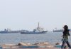Two Ships Sink, Another Damaged as Iran Intensifies Attacks in Strait of Hormuz Vessels in the Strait of Hormuz near the beach